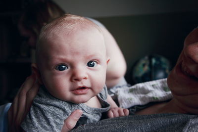 Close-up portrait of cute baby boy with father at home