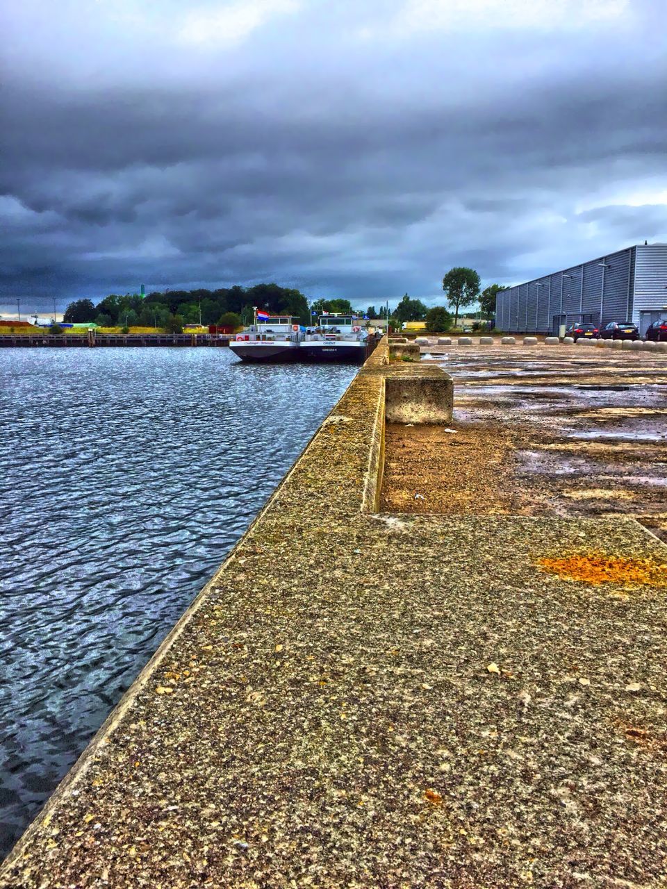 sky, cloud - sky, water, cloudy, built structure, architecture, building exterior, cloud, sea, the way forward, weather, overcast, pier, nature, tranquility, scenics, tranquil scene, outdoors, diminishing perspective, no people