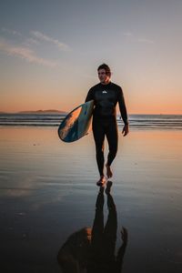 Full length of man on beach during sunset