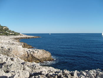 Scenic view of sea against clear blue sky