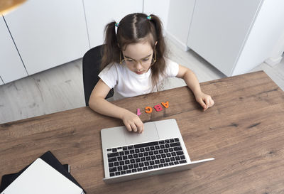 High angle view of woman using laptop at home