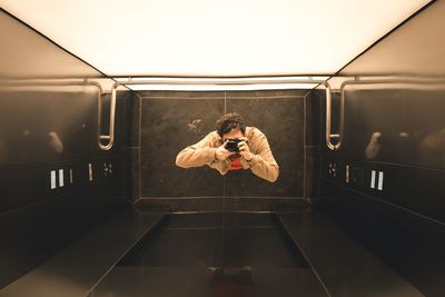 Man photographing by car