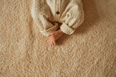 Low section of woman sitting on hardwood floor