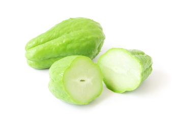 Close-up of green pepper over white background