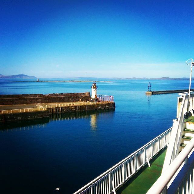 water, blue, sea, copy space, clear sky, pier, railing, tranquility, tranquil scene, scenics, built structure, nature, beauty in nature, horizon over water, architecture, sky, calm, idyllic, jetty, day