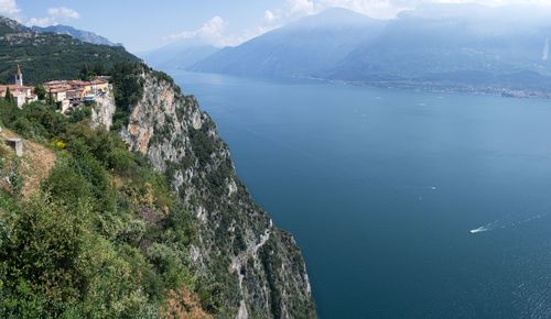 Scenic view of sea by town against sky