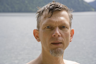 Close-up of portrait of mature man against sea