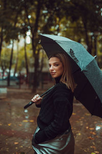 Portrait of a smiling young woman standing outdoors