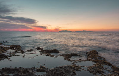 Scenic view of sea against sky at sunset