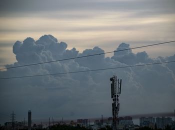 Low angle view of cables against sky in city