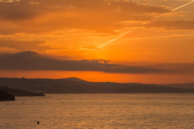 Scenic view of sea against romantic sky at sunset