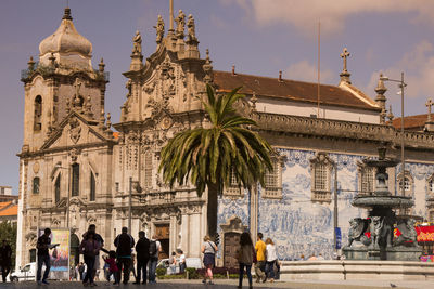 People walking by historic carmo convent in city