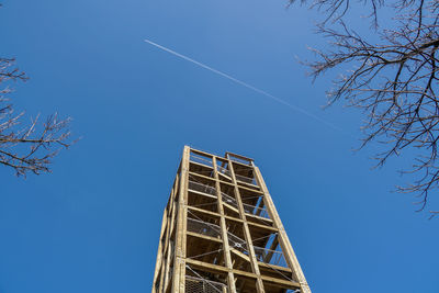 Low angle view of vapor trail against clear blue sky