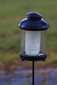 Close-up of tea light on field