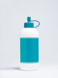 Close-up of green bottle against white background