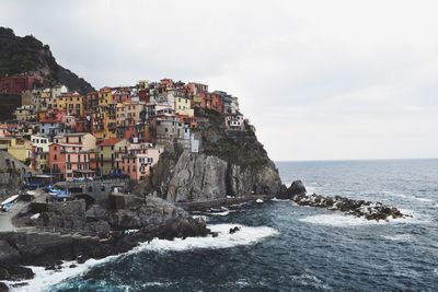 Scenic view of sea by cliff against sky