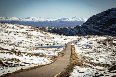 Scenic view of snow covered mountains against sky