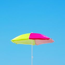 Low angle view of flag against clear blue sky