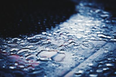 Full frame shot of raindrops on water