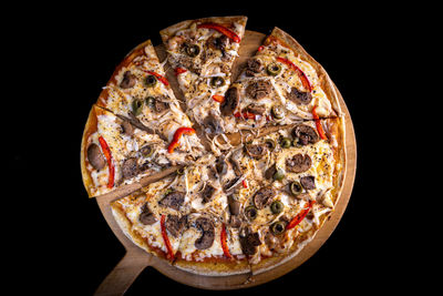 Close-up of pizza on black background