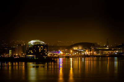 Illuminated city at waterfront
