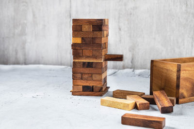 Close-up of stack on table against wall during winter