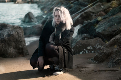 Woman kneeling at beach