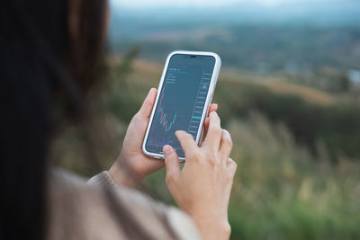 Midsection of woman using mobile phone