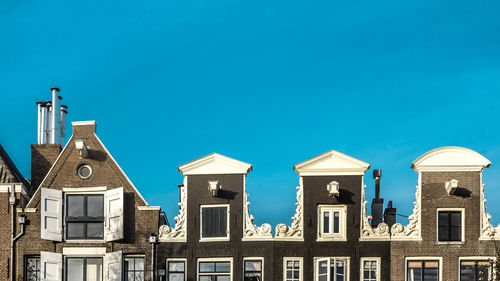 Low angle view of building against clear blue sky