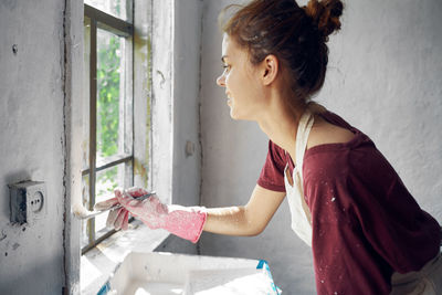 Side view of young woman working at home