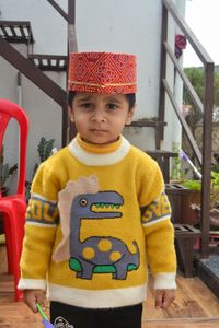 Portrait of cute baby boy standing outdoors