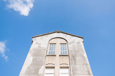 Low angle view of building against blue sky