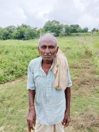 Portrait of man standing on field