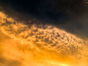 Low angle view of dramatic sky during sunset