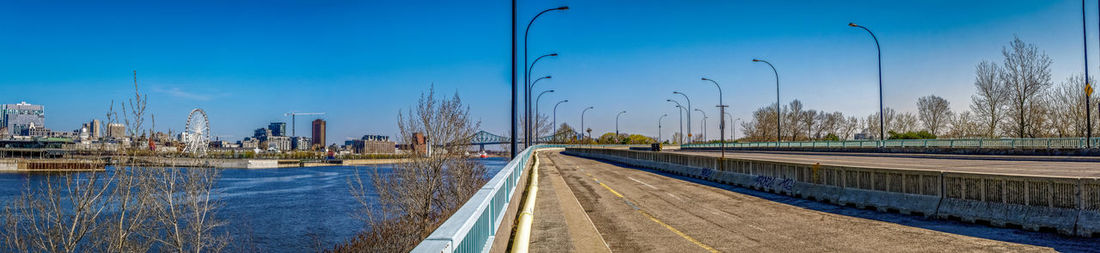 Panoramic view of river by city against blue sky