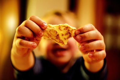 Close-up of baby boy holding food