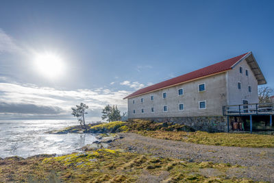 House by sea against sky