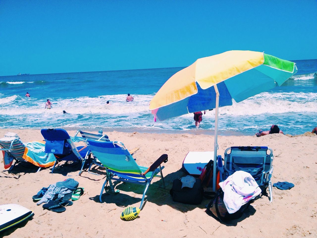 beach, sand, sea, shore, horizon over water, beach umbrella, clear sky, water, blue, vacations, parasol, summer, lounge chair, sunlight, tranquility, tranquil scene, deck chair, sunshade, sunny, nature