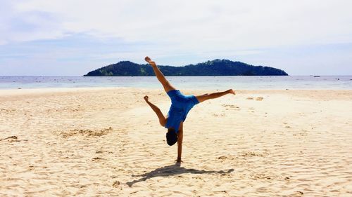 Full length of man on beach against sky