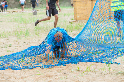 Low section of man jumping on field