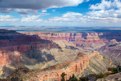 Scenic view of eroded landscape against cloudy sky at grand canyon national park