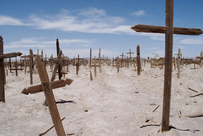 Graves in cemetery against blue sky