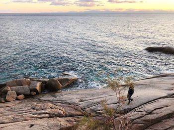 Scenic view of rocks on beach against sky