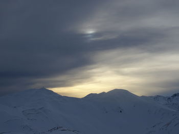 Scenic view of snow covered mountains against sky