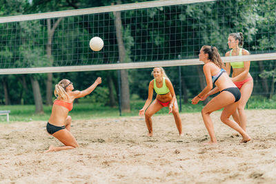 Young women playing beach volleyball