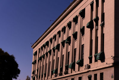 Low angle view of building against clear blue sky