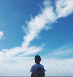 Silhouette of woman standing against cloudy sky