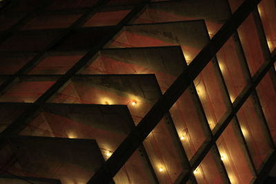 Low angle view of illuminated skylight in building