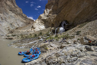 High angle view of inflatable rafts by mountains