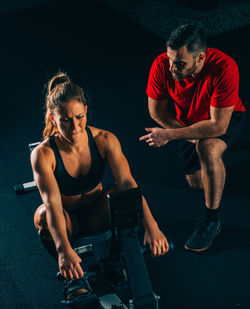 Young couple sitting on wall at home